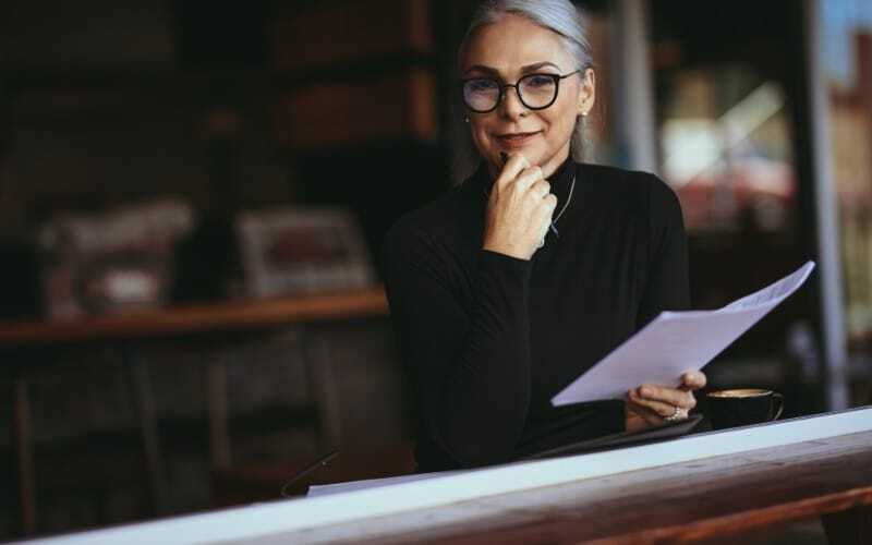 Businesswoman with glasses holding documents